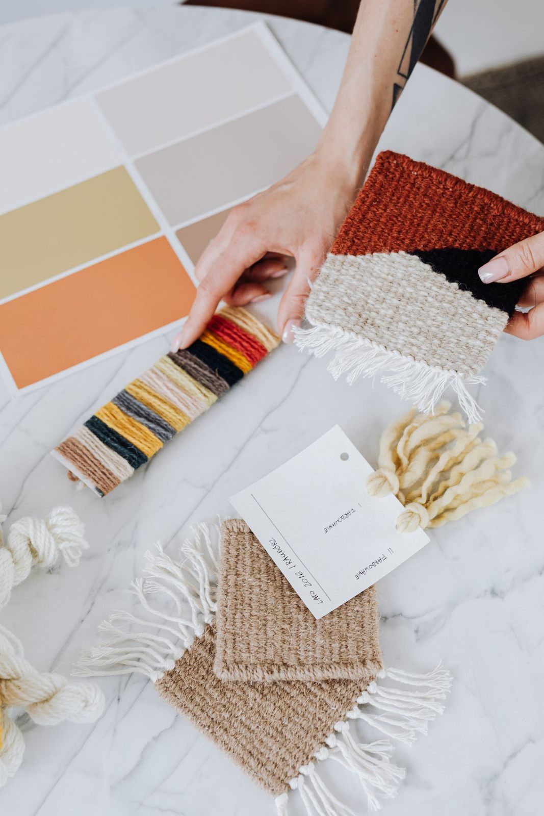 Interior designer holds textile samples for a renovation project, showcasing a modern and creative workspace
